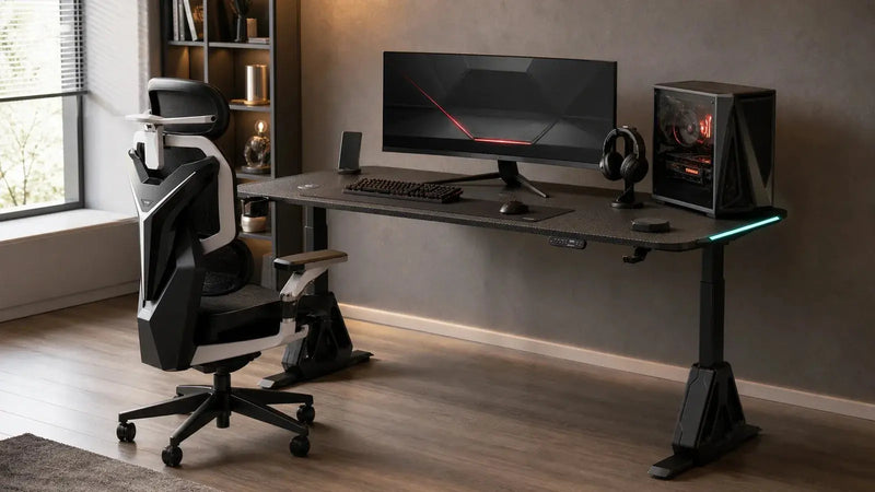 A black straight gaming desk with an ultrawide monitor and a black-and-white ergonomic gaming chair in a softly lit room