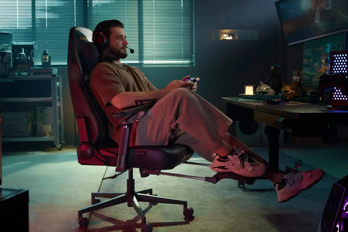 Gamer relaxing in an ergonomic gaming chair while playing with a controller and headset