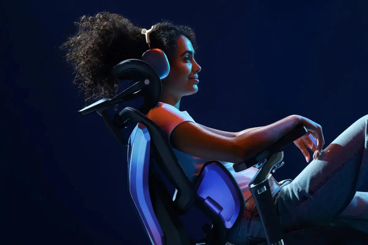 Woman sitting in an ergonomic gaming chair with headset in a dark gaming setup
